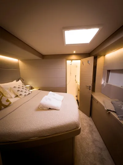 Esperance Yacht Photos Pics Luxurious cabin interior of 2024 Lagoon 55 yacht with cozy bed and modern design.