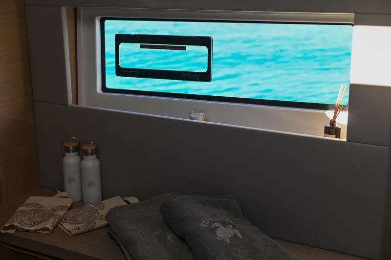 Esperance Yacht Photos Pics Luxurious interior of 2024 Lagoon 55 yacht with ocean view through window.