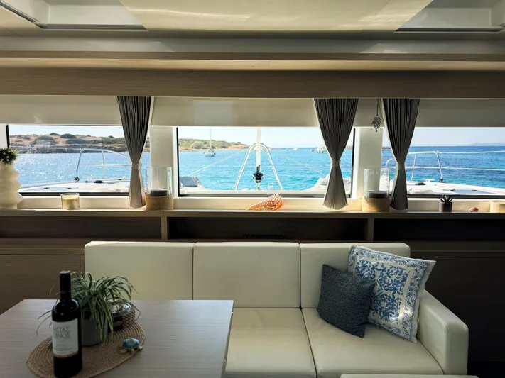 Esperance Yacht Photos Pics Luxurious interior of 2024 Lagoon 55 yacht with ocean view through large windows.