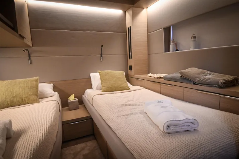 Esperance Yacht Photos Pics Luxurious twin cabin interior of 2024 Lagoon 55 yacht, featuring modern design and cozy bedding.
