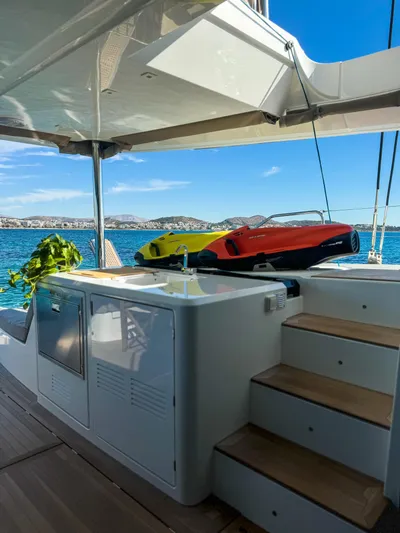 Esperance Yacht Photos Pics 2024 Lagoon 55 yacht interior with sea view and water sports equipment.