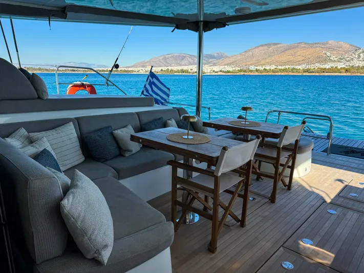 Esperance Yacht Photos Pics Luxurious Lagoon 55 yacht deck with seating, tables, and scenic ocean view, 2024 model.