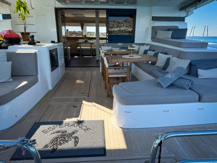 Esperance Yacht Photos Pics Luxurious 2024 Lagoon 55 yacht interior with elegant seating, dining area, and ocean view.