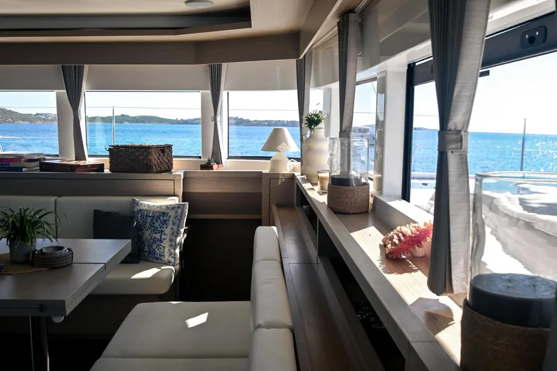 Esperance Yacht Photos Pics Luxurious interior of 2024 Lagoon 55 yacht with ocean view through large windows.