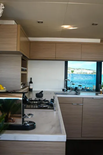 Esperance Yacht Photos Pics Modern kitchen interior on 2024 Lagoon 55 yacht with ocean view through window.