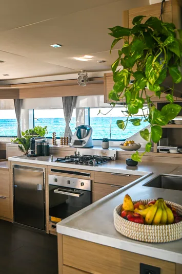 Esperance Yacht Photos Pics Modern kitchen interior on 2024 Lagoon 55 yacht with ocean view and fresh fruit.