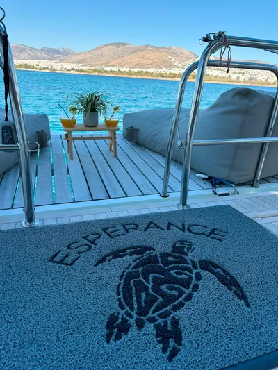 Esperance Yacht Photos Pics Luxury yacht deck with sea view, featuring a mat with turtle design, Lagoon 55, 2024 model.