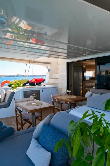 Esperance Yacht Photos Pics Luxurious 2024 Lagoon 55 yacht interior with cozy seating and dining area.