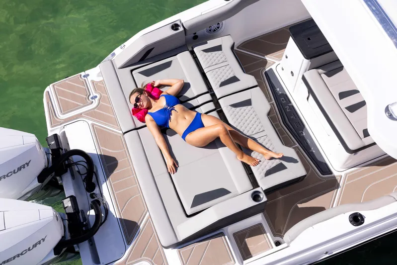 Yacht Photos Pics Woman relaxing on a 2026 Monterey ELITE 30 boat, sunbathing on deck.