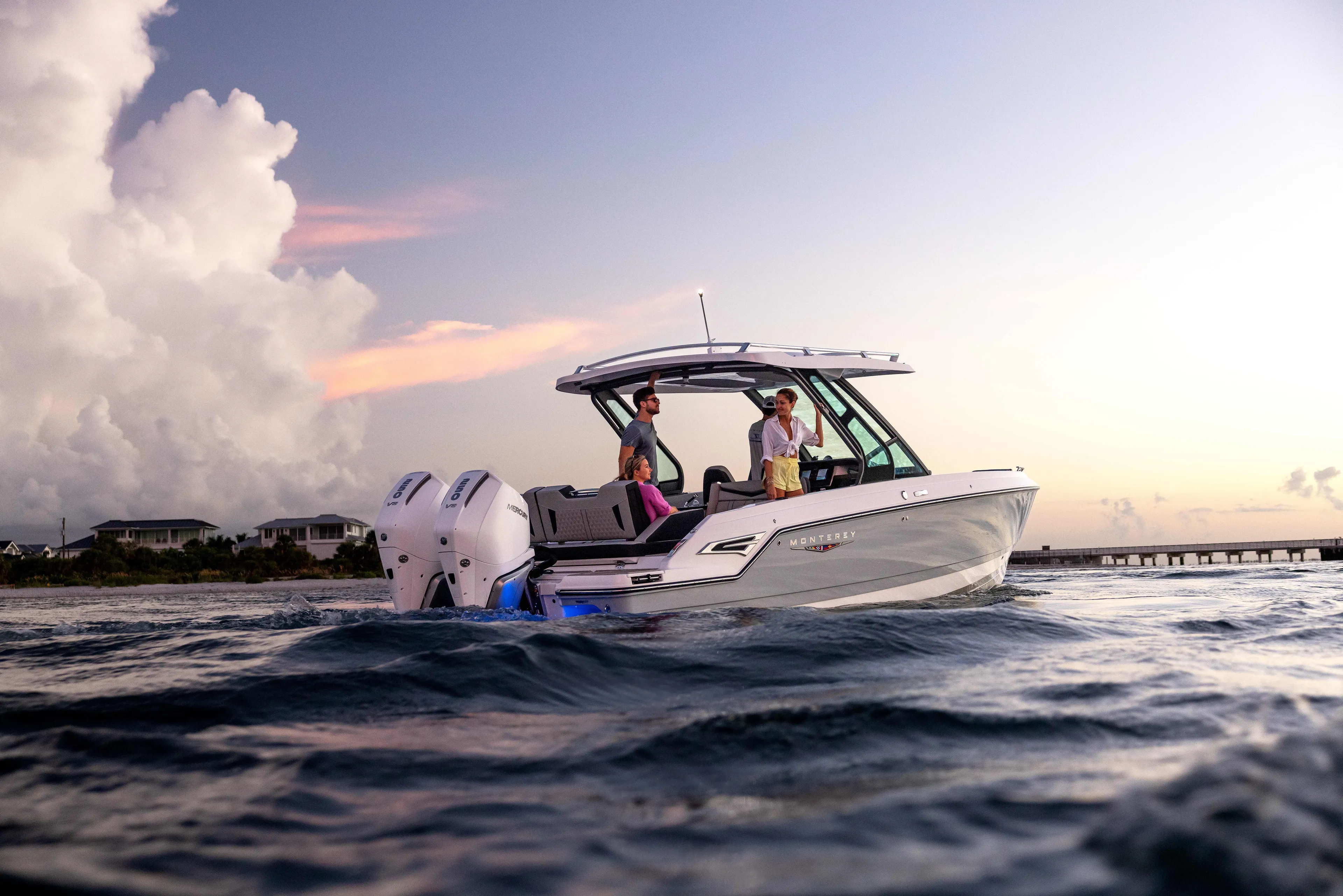  Yacht Photos Pics 2026 Monterey ELITE 30 boat cruising on open water at sunset.