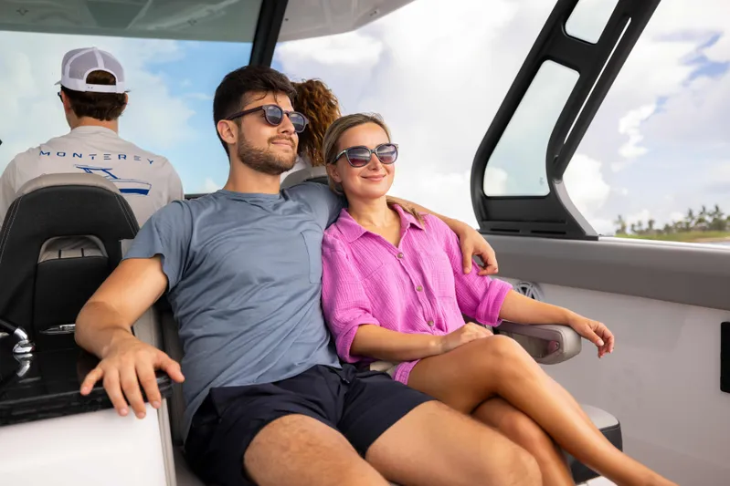  Yacht Photos Pics Couple relaxing on a 2026 Monterey ELITE 30 boat, enjoying a sunny day.