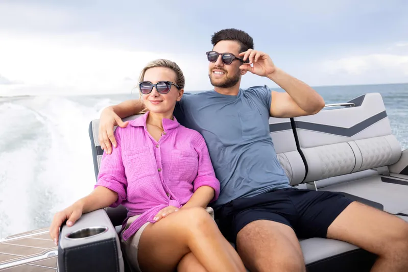  Yacht Photos Pics Couple enjoying a ride on a 2026 Monterey ELITE 30 boat, wearing sunglasses.