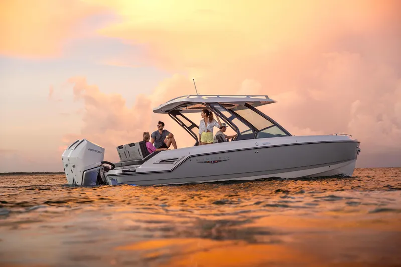  Yacht Photos Pics 2026 Monterey ELITE 30 boat cruising at sunset with passengers enjoying the view.