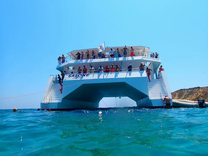 Salone Yacht Photos Pics 2015 Power Catamaran with passengers on deck in clear blue waters.