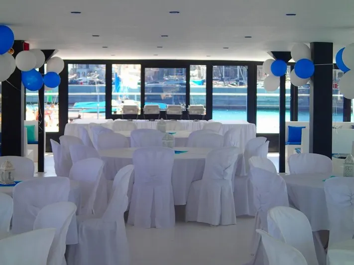 Salone Yacht Photos Pics Interior of a 2015 Power Catamaran decorated for an event with white and blue balloons.