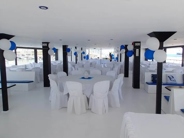Salone Yacht Photos Pics Interior of a 2015 Power Catamaran decorated for an event with white and blue balloons.