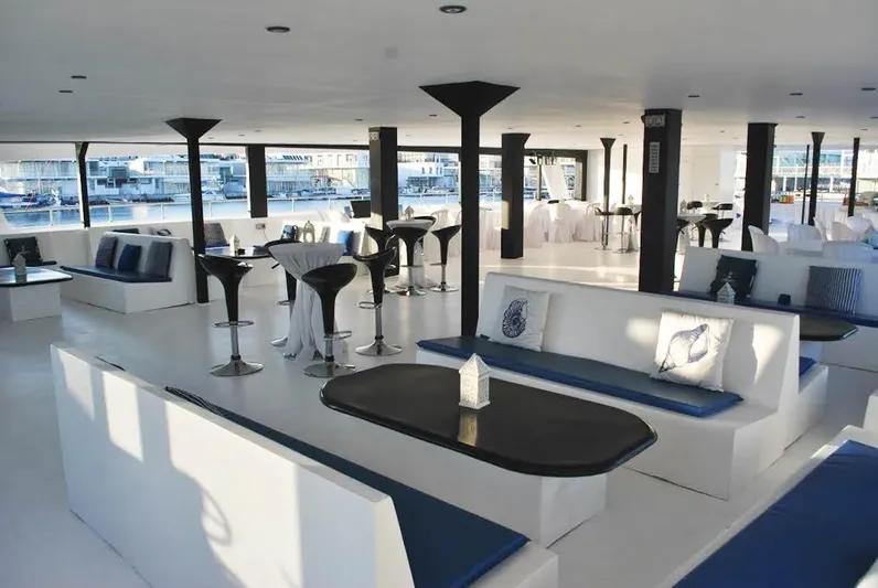 Salone Yacht Photos Pics Luxurious interior of a 2015 Power Catamaran with modern seating and tables.