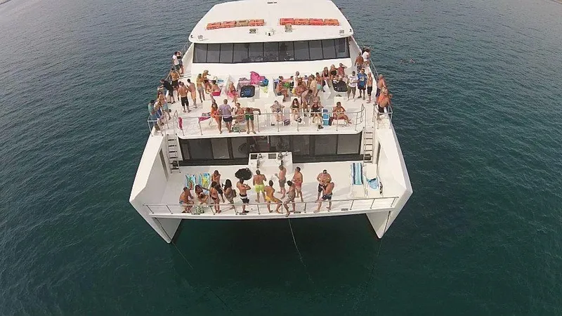 Salone Yacht Photos Pics Aerial view of a 2015 Power Catamaran with people enjoying a party on deck.