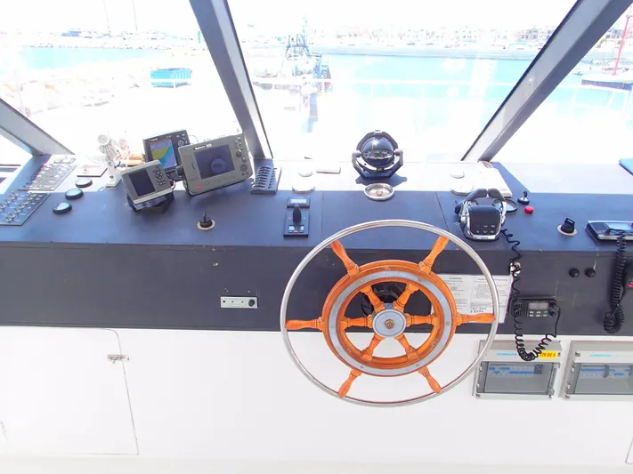 Salone Yacht Photos Pics Control panel of a 2015 Power Catamaran with navigation instruments and steering wheel.