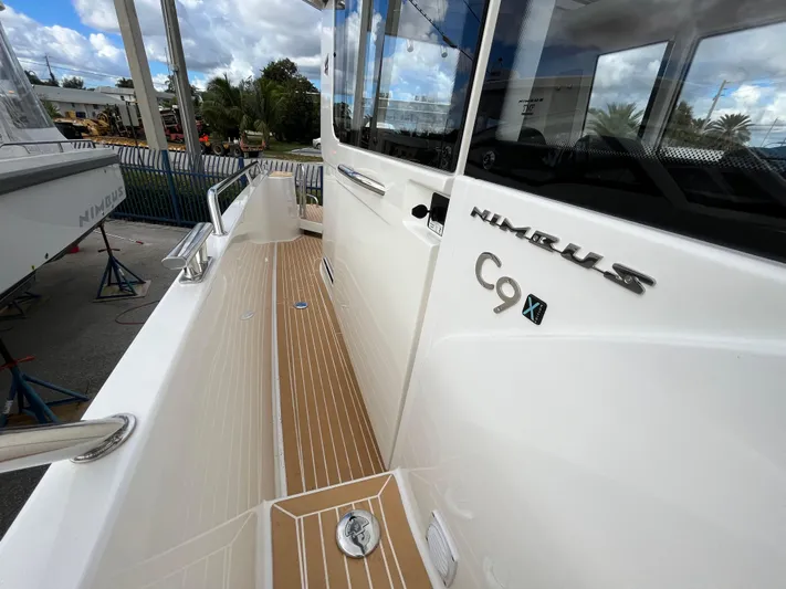 In-stock 2024 Nimbus C9 #136 Yacht Photos Pics 2024 Nimbus Commuter 9 #136 boat exterior with teak deck and sleek design.