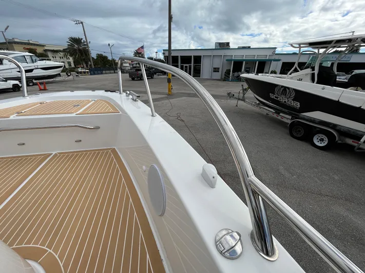 In-stock 2024 Nimbus C9 #136 Yacht Photos Pics 2024 Nimbus Commuter 9 #136 boat deck with stainless steel railings and wood finish.