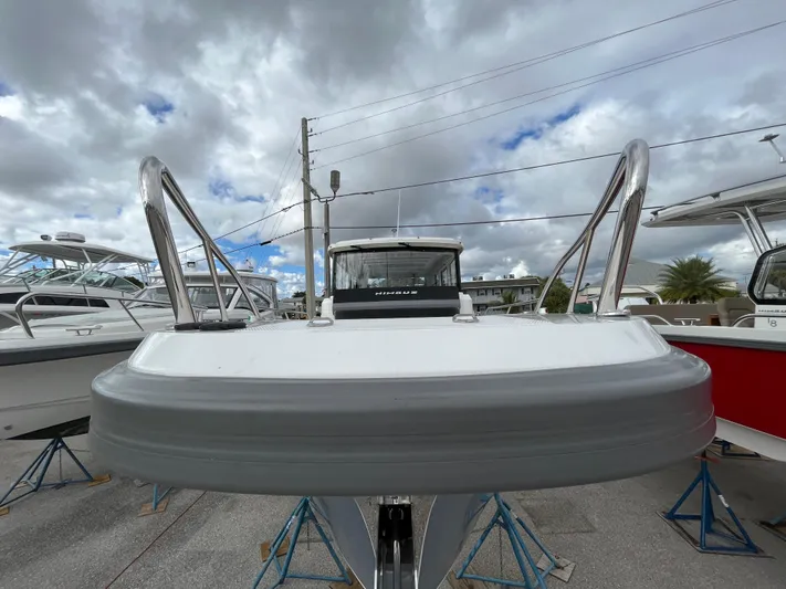 In-stock 2024 Nimbus C9 #136 Yacht Photos Pics 2024 Nimbus Commuter 9 #136 boat on stands under cloudy sky.