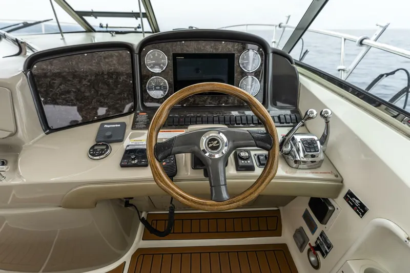  Yacht Photos Pics Helm of 2008 Sea Ray 38 Sundancer with wooden steering wheel and modern controls.