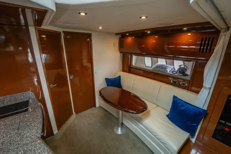  Yacht Photos Pics Interior of 2008 Sea Ray 38 Sundancer yacht with seating area and wooden table.