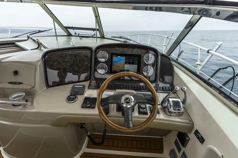  Yacht Photos Pics Helm of 2008 Sea Ray 38 Sundancer with navigation controls and wooden steering wheel.
