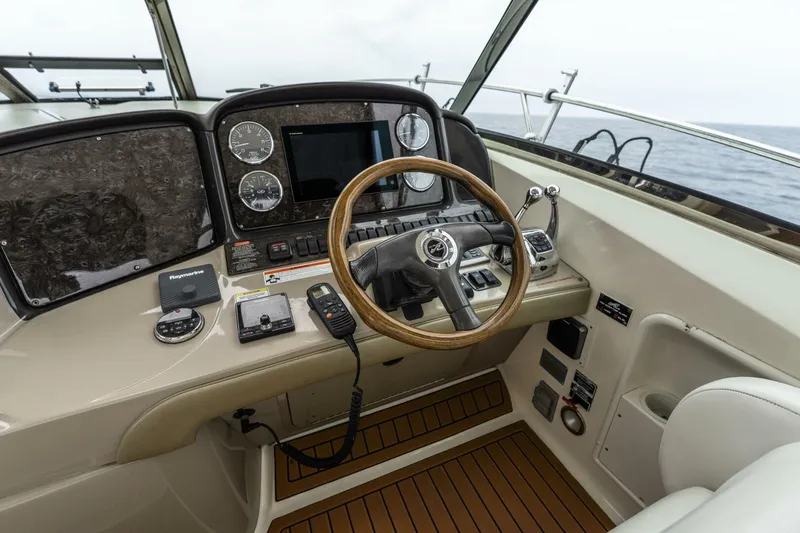  Yacht Photos Pics Helm of 2008 Sea Ray 38 Sundancer with wooden steering wheel and navigation instruments.