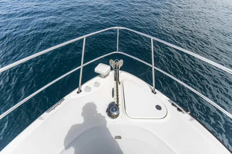  Yacht Photos Pics Bow of 2008 Sea Ray 38 Sundancer yacht on calm blue water.