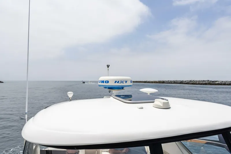  Yacht Photos Pics 2008 Sea Ray 38 Sundancer boat on calm water, featuring radar equipment on the roof.