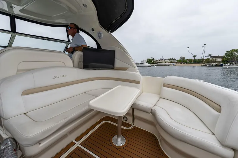  Yacht Photos Pics 2008 Sea Ray 38 Sundancer yacht interior with white seating and table, overlooking calm waters.