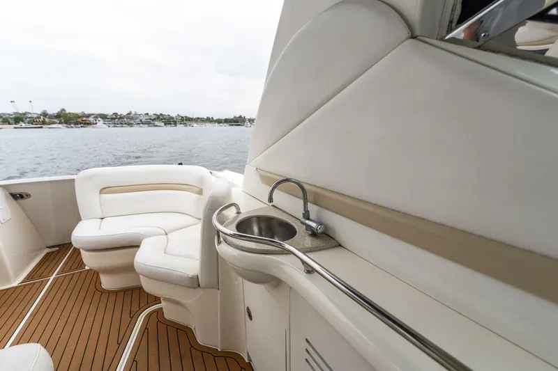  Yacht Photos Pics 2008 Sea Ray 38 Sundancer yacht interior with seating and sink, overlooking water.