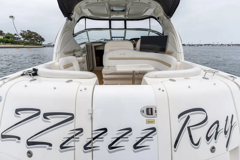  Yacht Photos Pics 2008 Sea Ray 38 Sundancer yacht with spacious seating, docked on calm water.