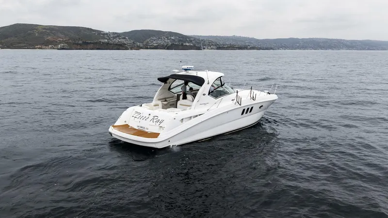  Yacht Photos Pics 2008 Sea Ray 38 Sundancer yacht cruising on open water, with scenic coastal background.