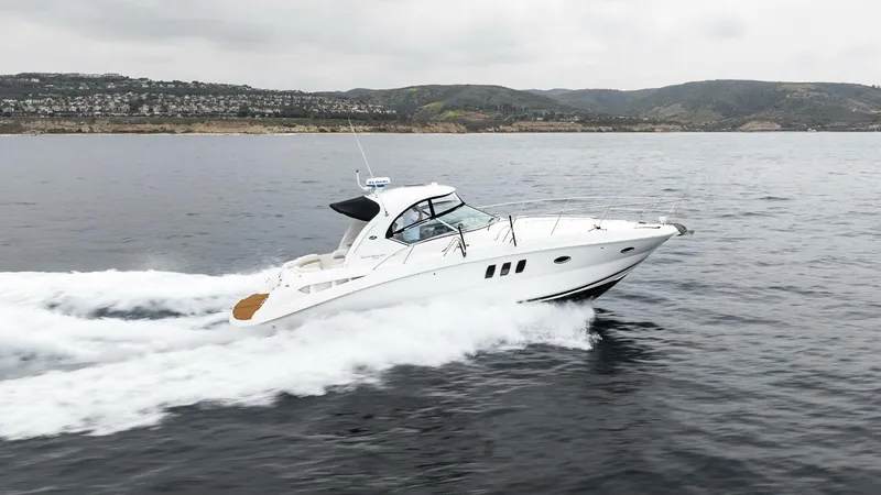  Yacht Photos Pics 2008 Sea Ray 38 Sundancer cruising on open water with scenic coastal backdrop.