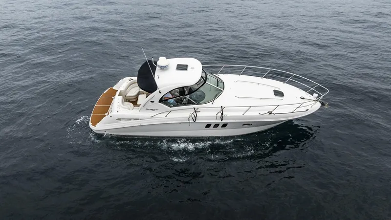  Yacht Photos Pics 2008 Sea Ray 38 Sundancer cruising on open water, aerial view.