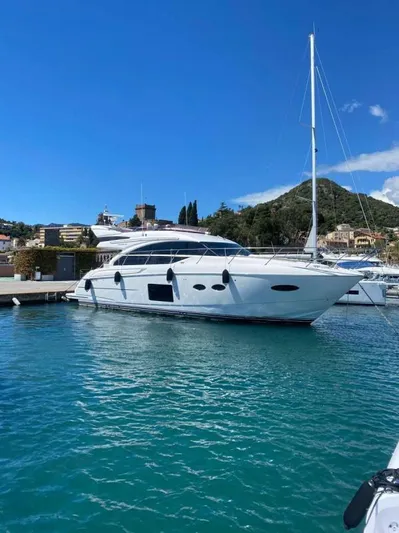  Yacht Photos Pics 2013 Princess Flybridge 52 Motor Yacht docked in a scenic marina.