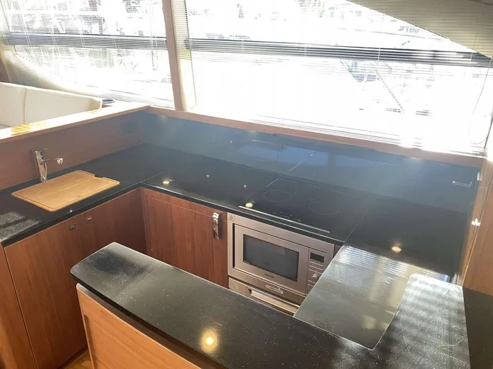  Yacht Photos Pics Luxurious kitchen interior of 2013 Princess Flybridge 52 Motor Yacht with modern appliances.