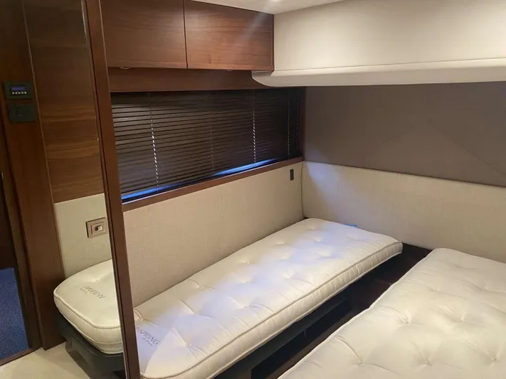  Yacht Photos Pics Twin beds in a 2013 Princess Flybridge 52 Motor Yacht cabin, featuring wood accents and blinds.