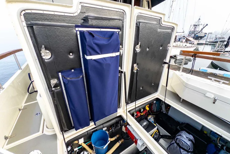  Yacht Photos Pics Open storage compartment on 2020 Targa 32 boat, showcasing organized equipment and tools.