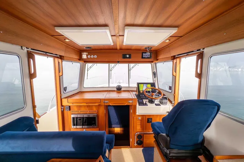  Yacht Photos Pics Interior of 2020 Targa 32 boat with wooden finish and blue seating.