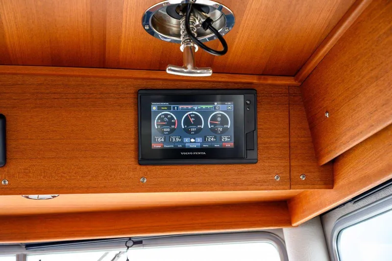  Yacht Photos Pics 2020 Targa 32 boat dashboard with Volvo Penta display, wooden interior.