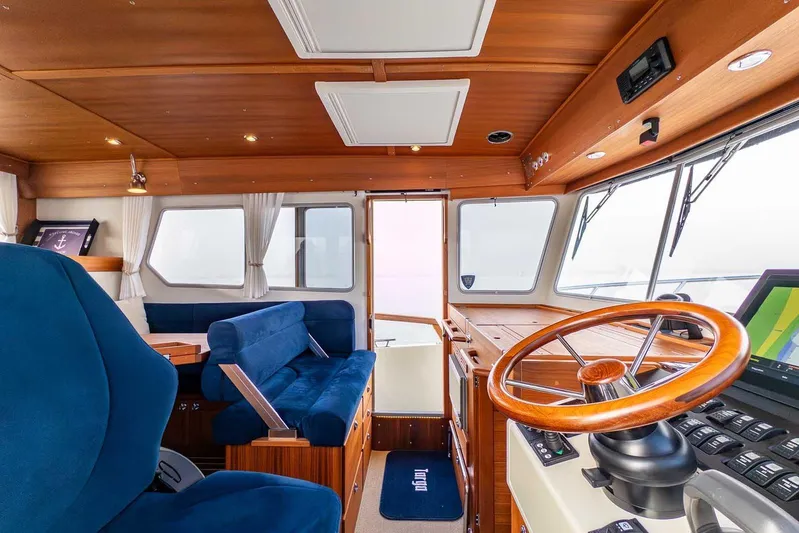  Yacht Photos Pics Interior of 2020 Targa 32 boat with wooden helm and blue seating.