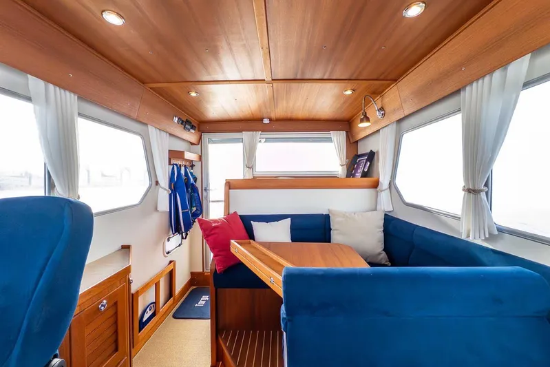  Yacht Photos Pics Interior of 2020 Targa 32 boat with blue seating and wooden accents.