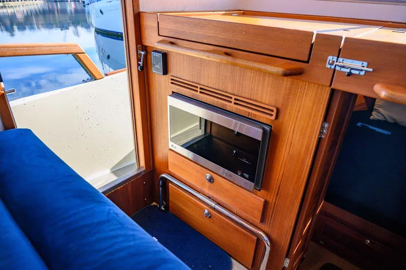  Yacht Photos Pics Interior of 2020 Targa 32 boat with wooden cabinetry and built-in microwave.