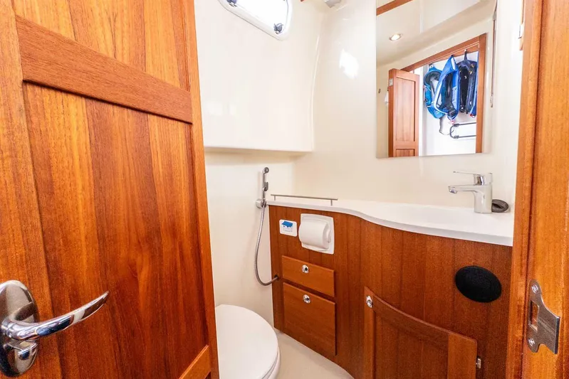  Yacht Photos Pics 2020 Targa 32 yacht bathroom with wooden cabinetry and modern fixtures.
