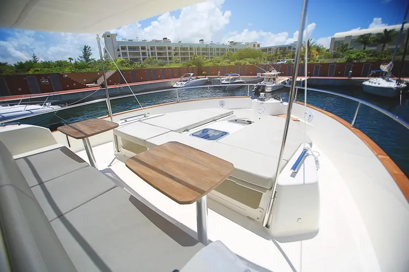  Yacht Photos Pics 2017 Cranchi Eco Trawler 53 Long Distance yacht deck with seating and tables in marina.