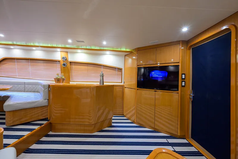 Goin Deep Yacht Photos Pics Luxurious interior of a 2014 Bertram 700 yacht with modern wood finishes and striped flooring.